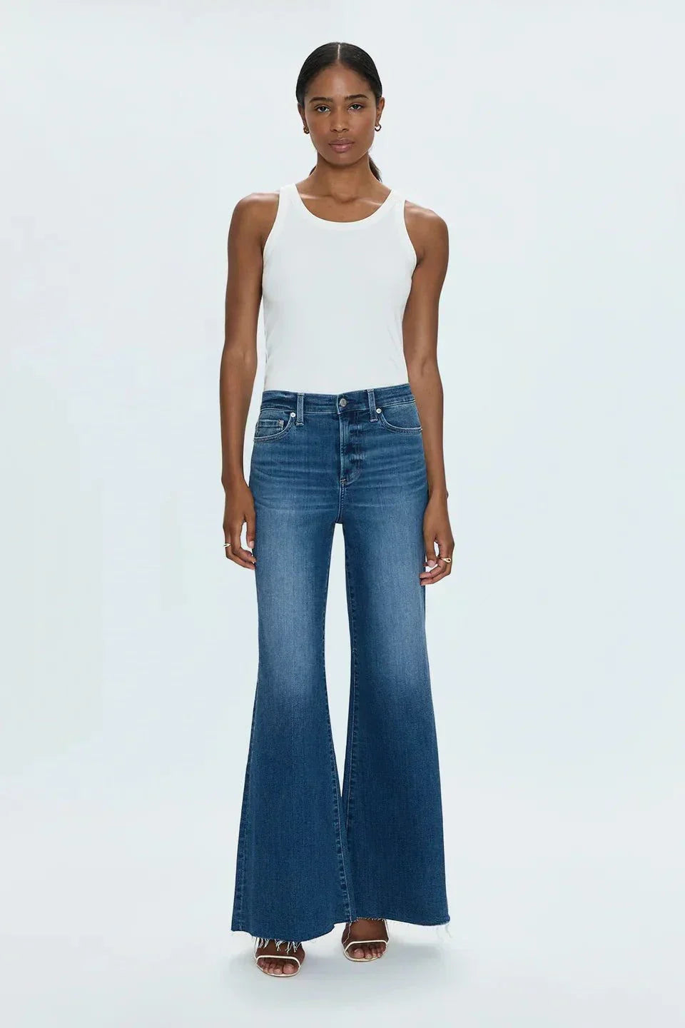 Woman wearing Izzy Jeans Study PISTOLA high-rise slim straight-leg denim jeans with worn-in wash