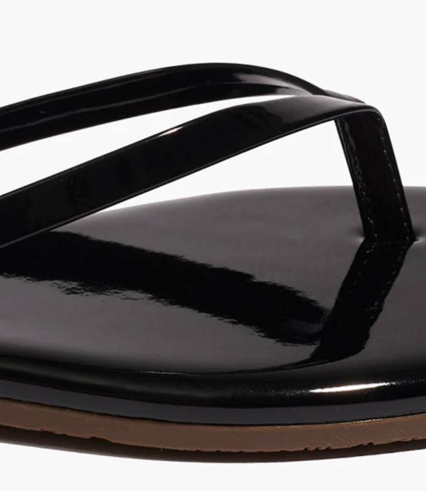 Close-up of black Lily Squares Licorice TKEES sandal with sleek modern design and shiny finish