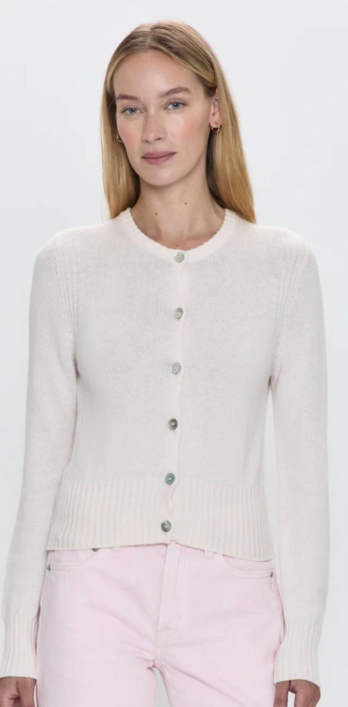 Woman wearing Taye Shrunken Cardi in barely pink with button-up front and soft cashmere blend