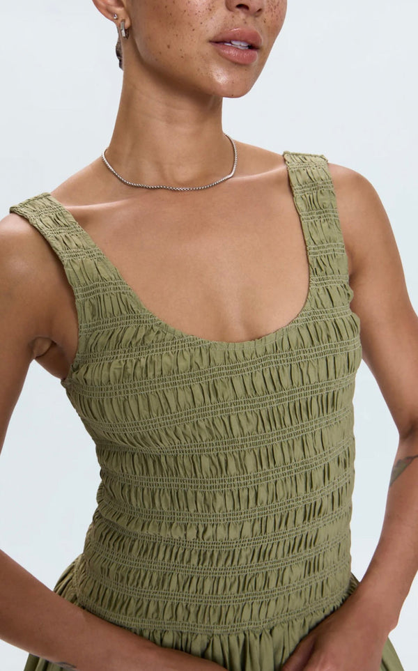 Woman wearing Alessia Dress in sage green with textured fabric and wide straps