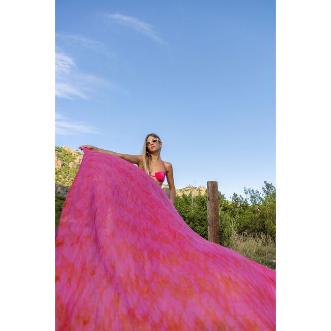 Woman wearing pink cashmere dip dye pareo with hibiscus flower pattern outdoors