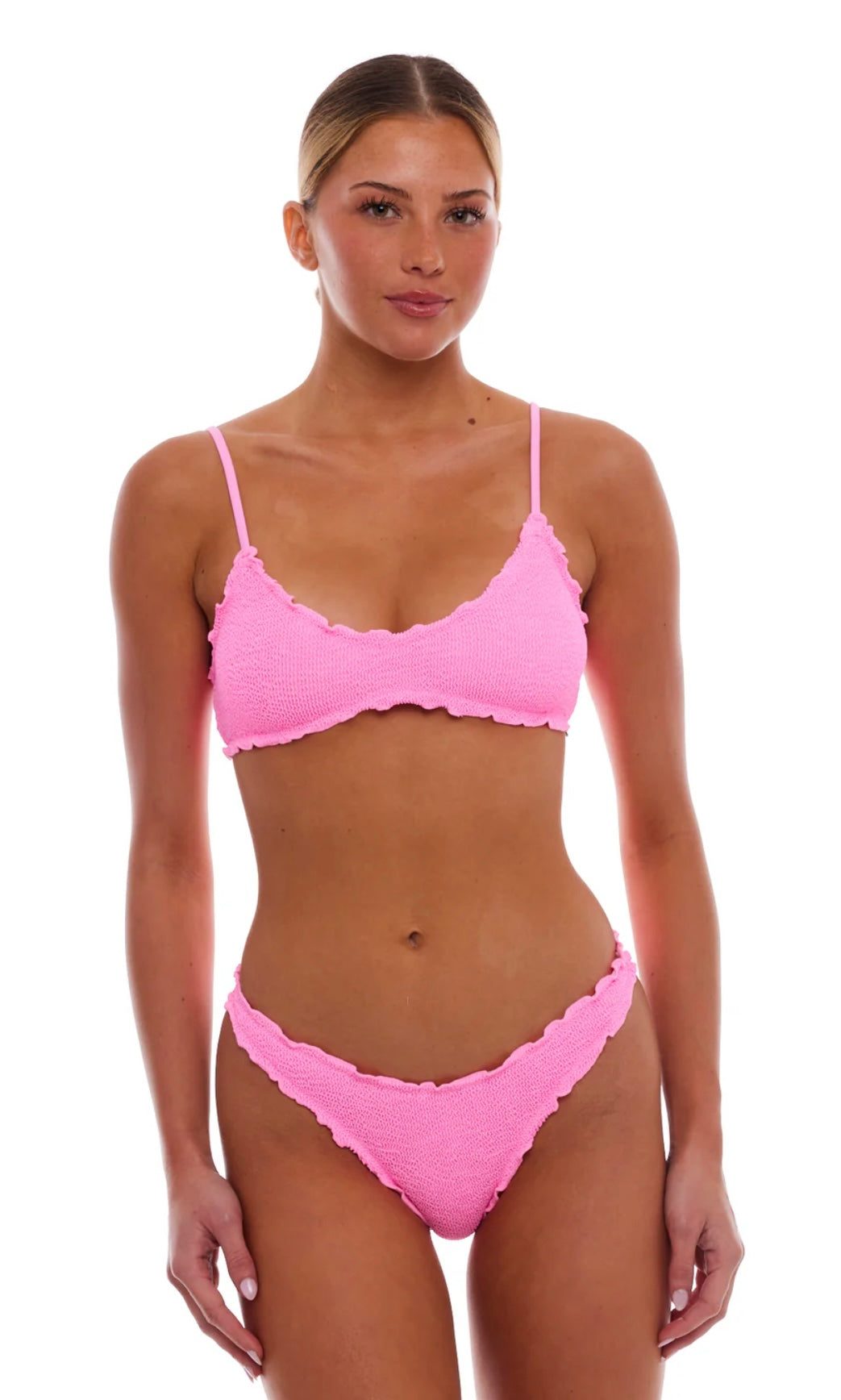 Woman wearing Cyprus Strawberry Pink textured bikini set with scalloped edges