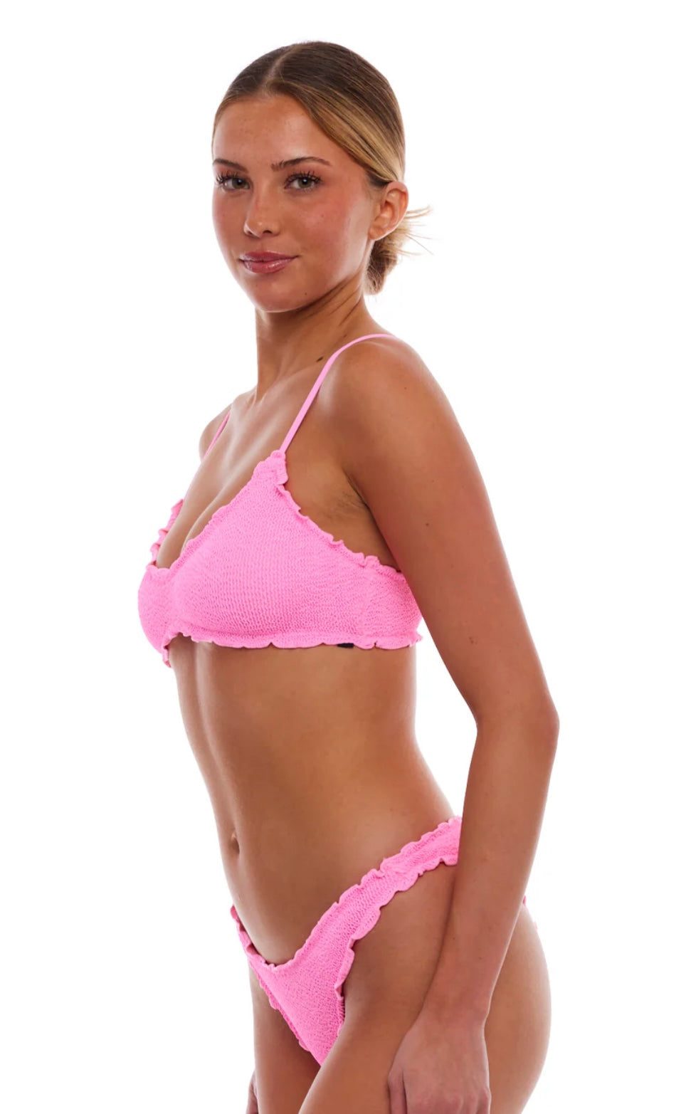 Woman wearing Cyprus Strawberry Pink textured bikini set with ruffled edges