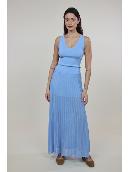 Woman wearing The Bridget Skirt Bleu by SOLID&STRIPED, a blue pleated maxi skirt with elasticated waist.