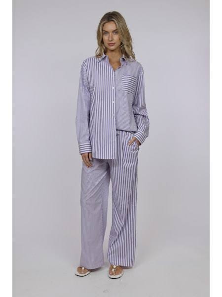 Woman wearing The Ashling Pant by SOLID&STRIPED striped pajama set with matching shirt