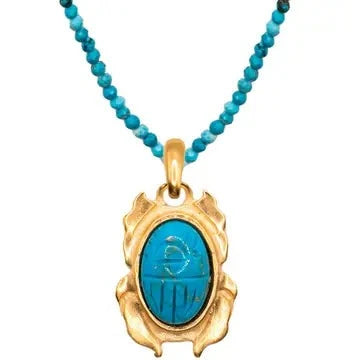 Mini fish necklace with turquoise bead chain and gold-tone fish pendant featuring blue stone center