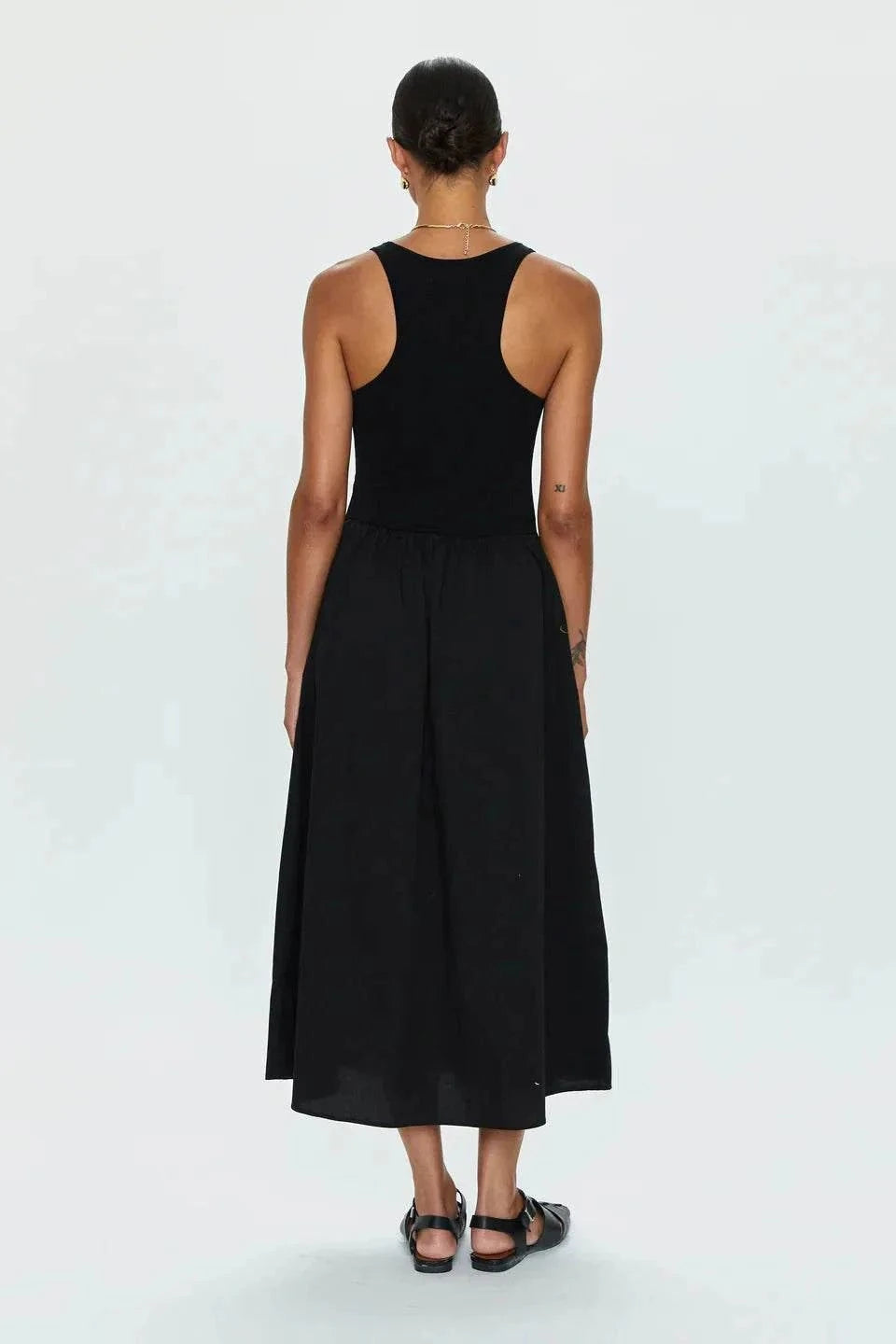 Back view of woman wearing black Faye Tank Dress with sleeveless top and relaxed skirt