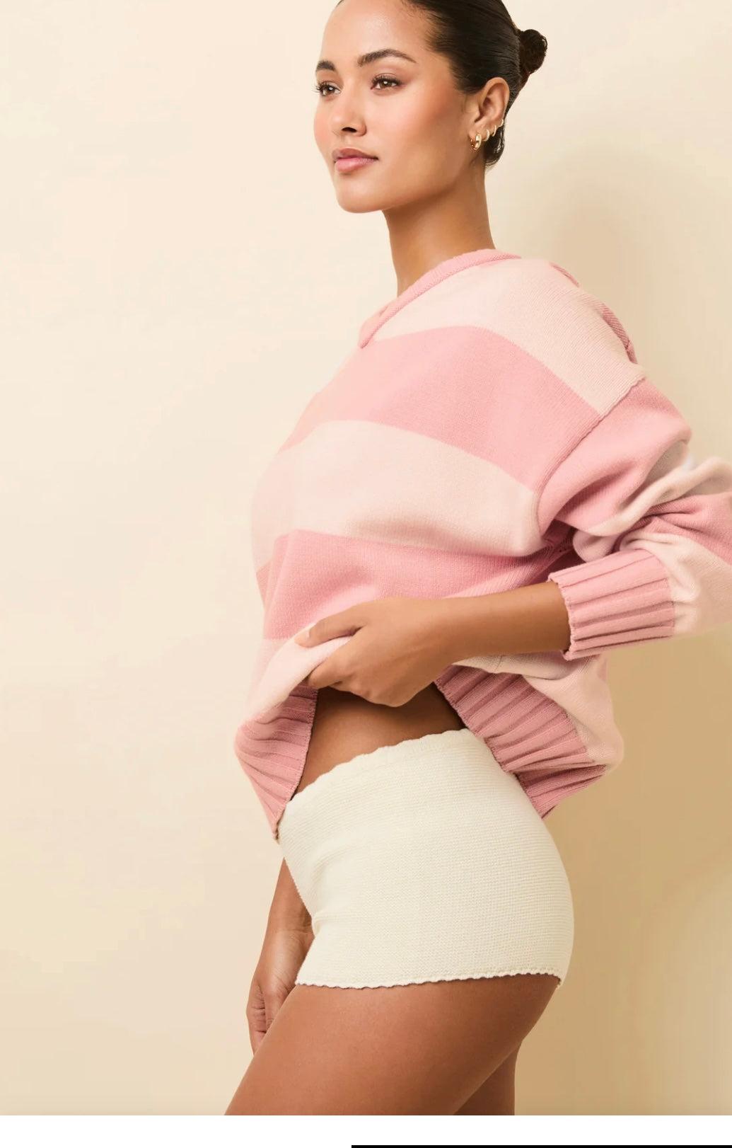 Woman wearing The Celeste Short écru with scalloped edges and pink striped sweater