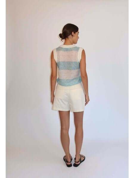 The Zola Tank wool blended vest in pastel blue and ércu stripes worn with white shorts from the back view