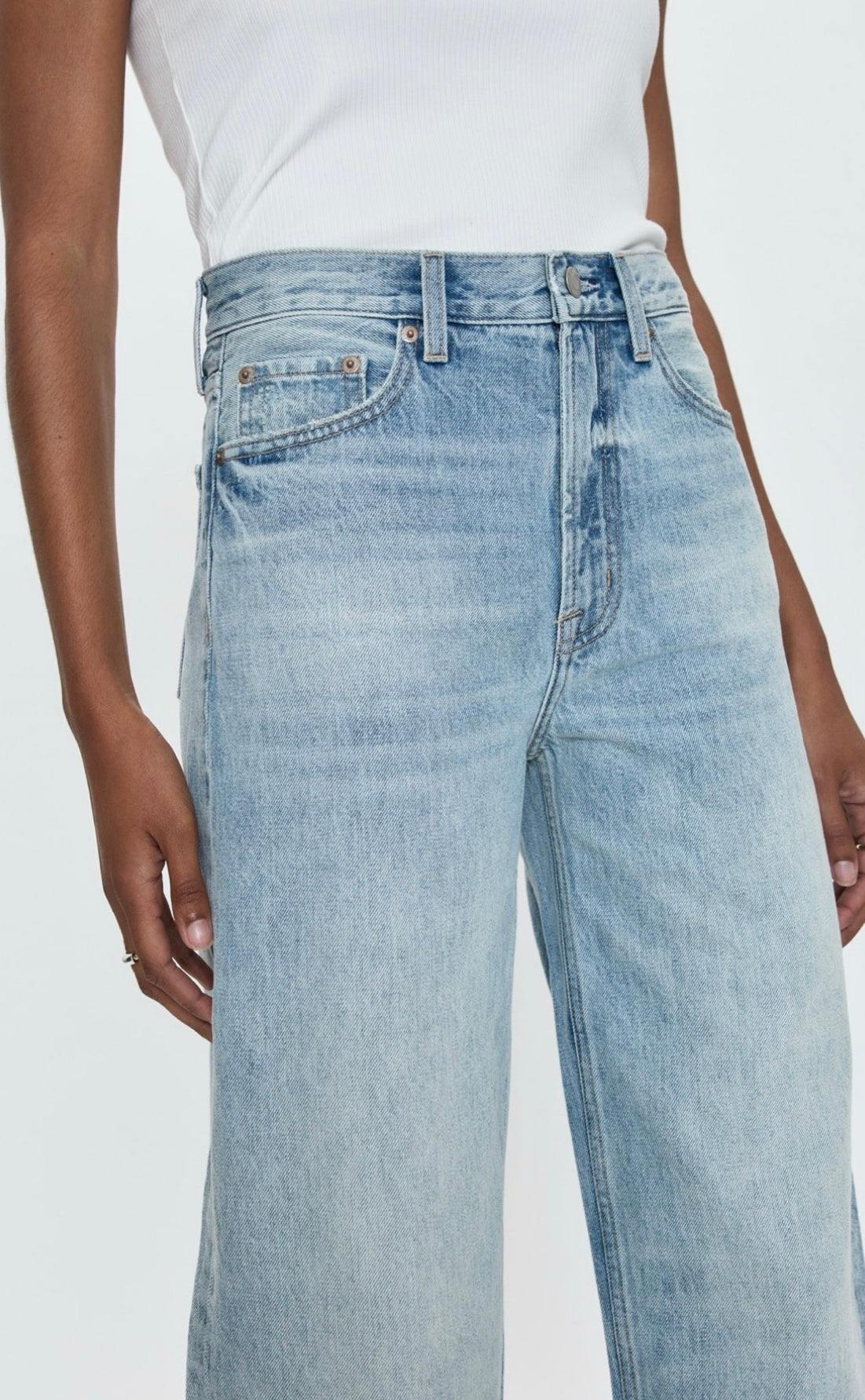 Woman wearing Wes High Rise barrel cut light blue denim jeans