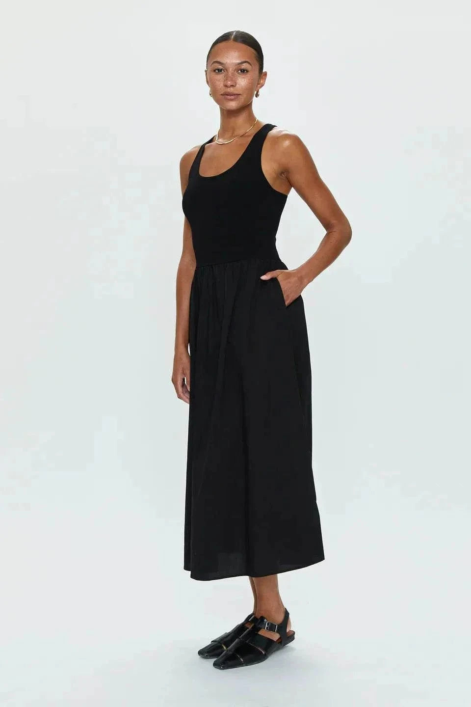 Model wearing Faye Tank Dress in noir black with sleeveless top and relaxed skirt