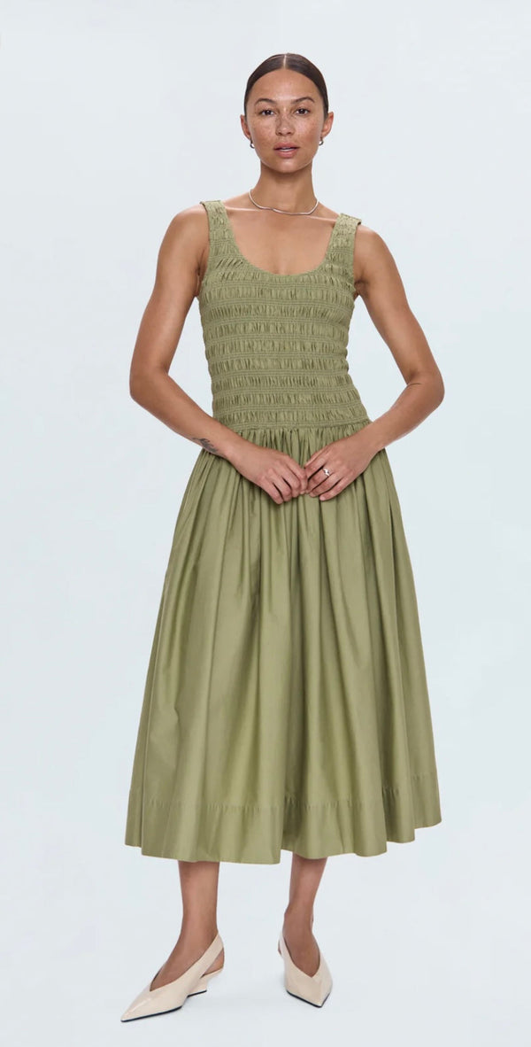 Woman wearing sage green Alessia Dress with fitted bodice and flowing midi skirt