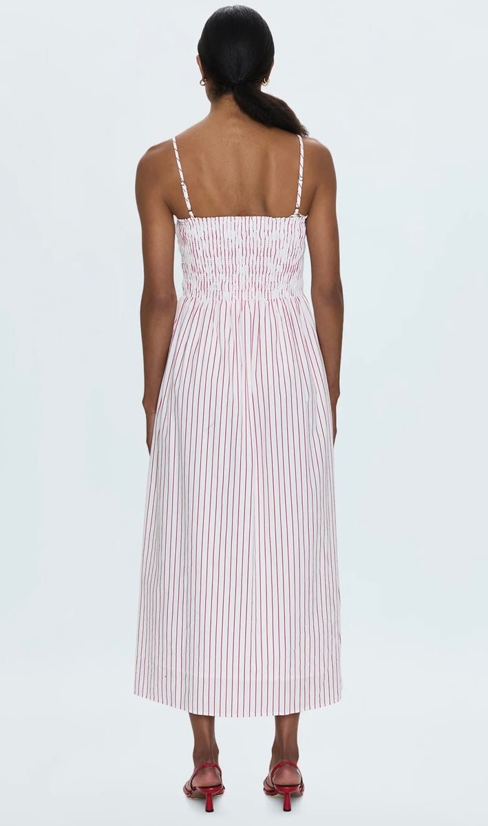 Back view of woman wearing Bianca Shirred Dress with ruby red stripes and smocked bodice.