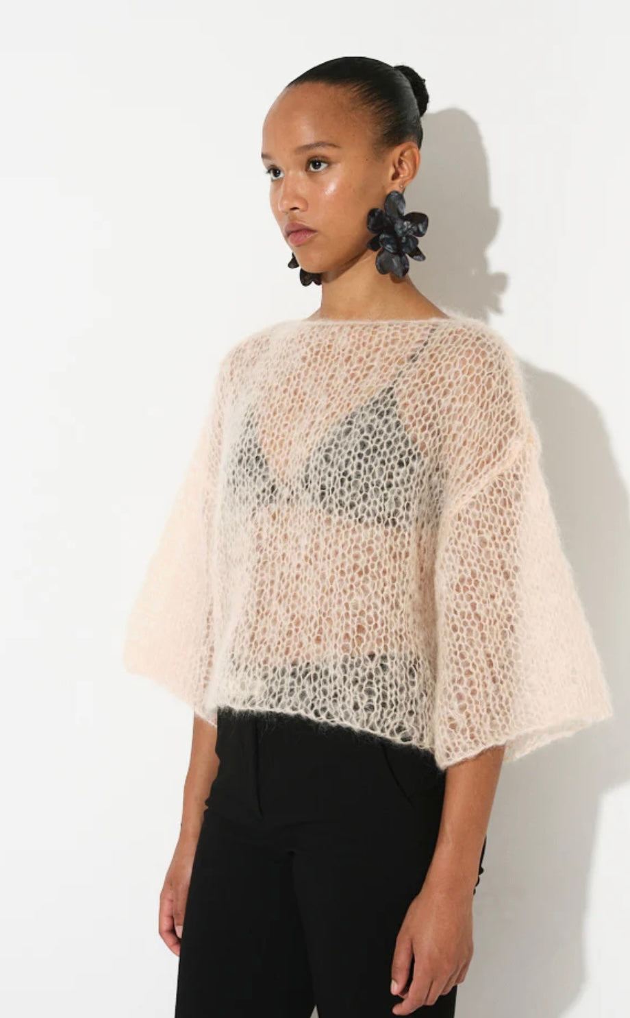 Woman wearing light butter-colored mohair T-shirt with 3/4 sleeves and oversized fit by MAIAMI Berlin