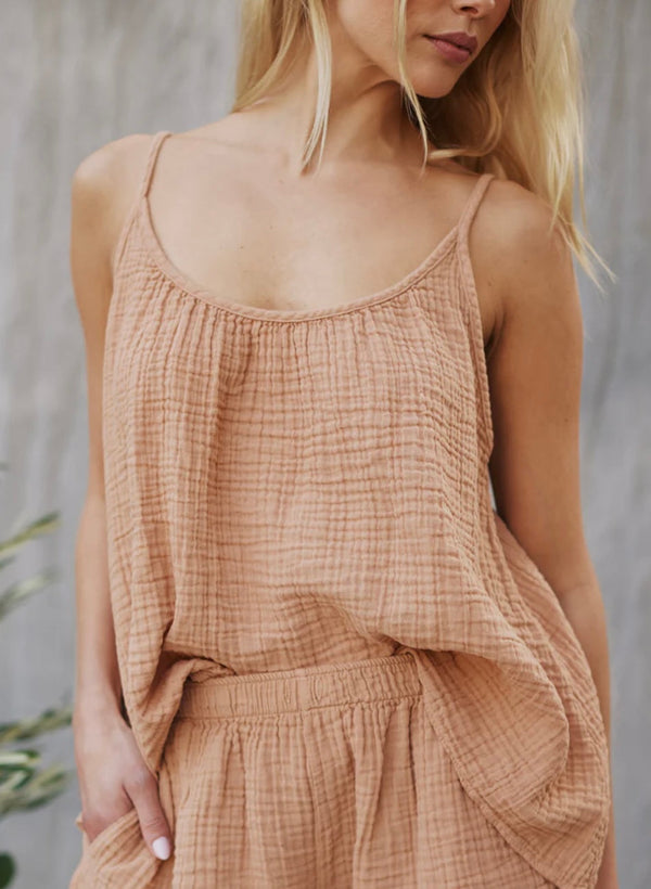 Woman wearing a loose-fitting Playa Top Latte in light brown with thin straps and matching bottoms