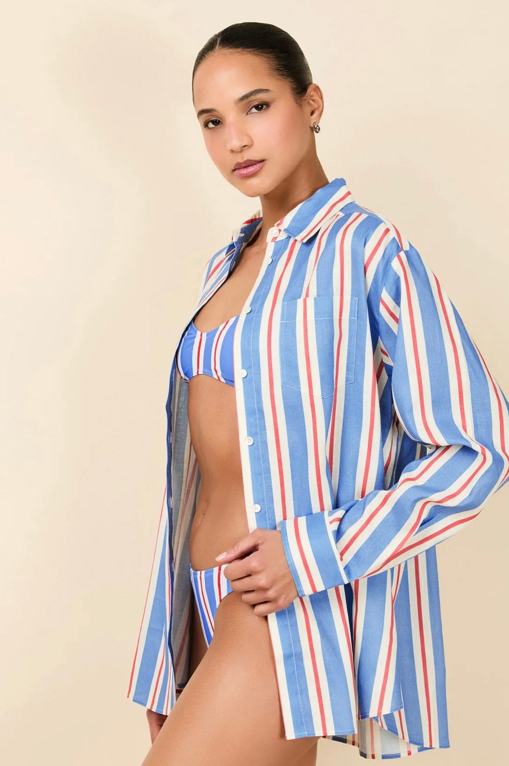 Woman wearing The Avril Button Down Americana striped linen shirt over swimsuit