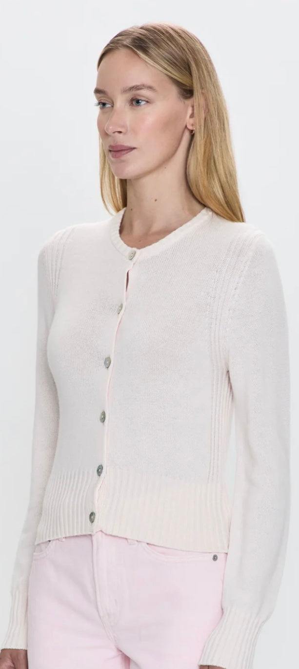 Woman wearing Taye Shrunken Cardi in barely pink, soft cashmere blend cardigan with buttons