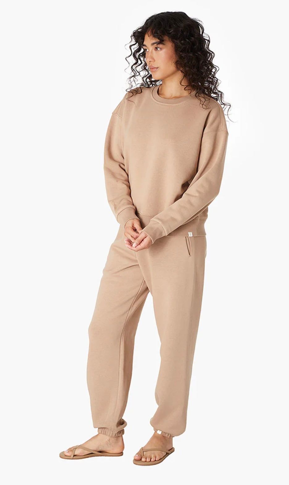 Woman wearing camel Air Whipped Crew & Pants set by TKEES standing against white background