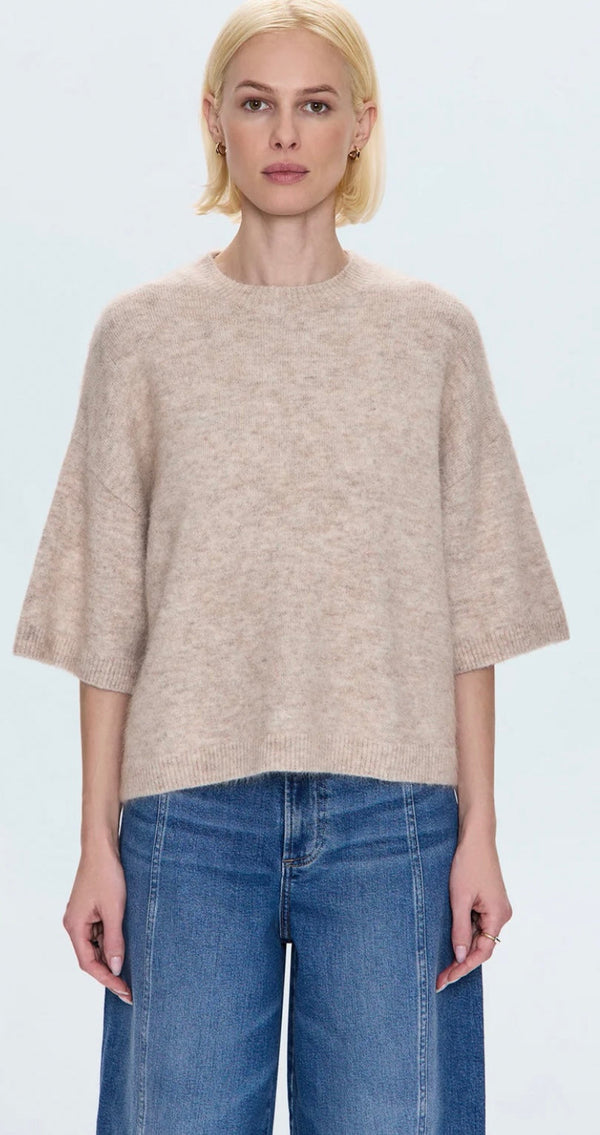 Woman wearing oatmeal Shiloh Sweater with short sleeves and relaxed fit paired with blue jeans