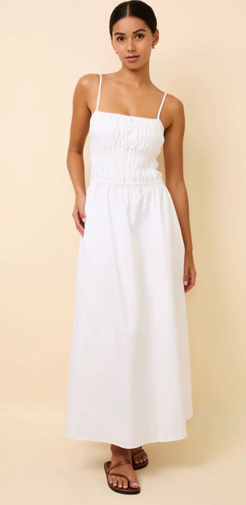Woman wearing The Delta White SOLID&STRIPED midi dress with smocked bodice and adjustable straps