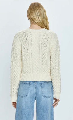 Back view of a woman wearing Quinn Ivory cable knit sweater and light blue Pistola denim jeans