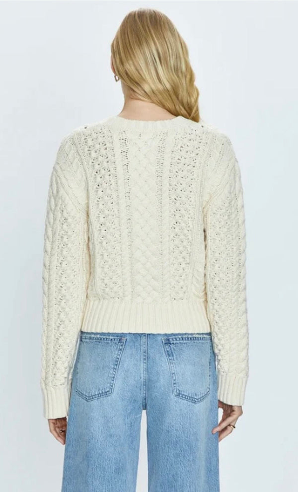 Back view of a woman wearing Quinn Ivory cable knit sweater and light blue Pistola denim jeans