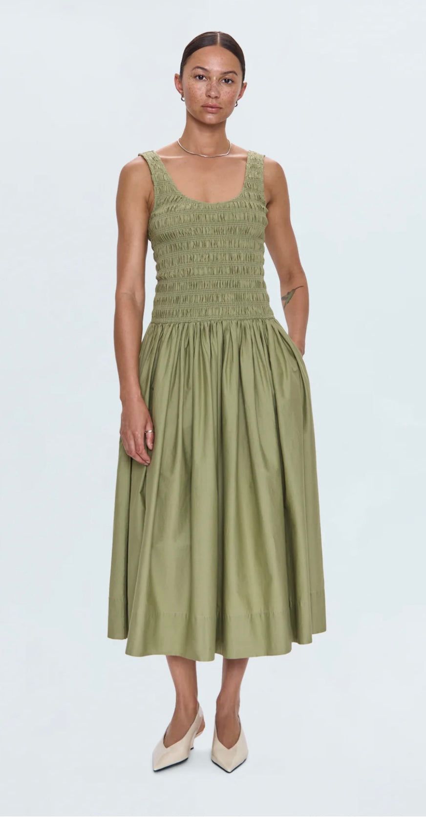 Woman wearing Alessia Dress sage green ruched midi tank dress with side pockets