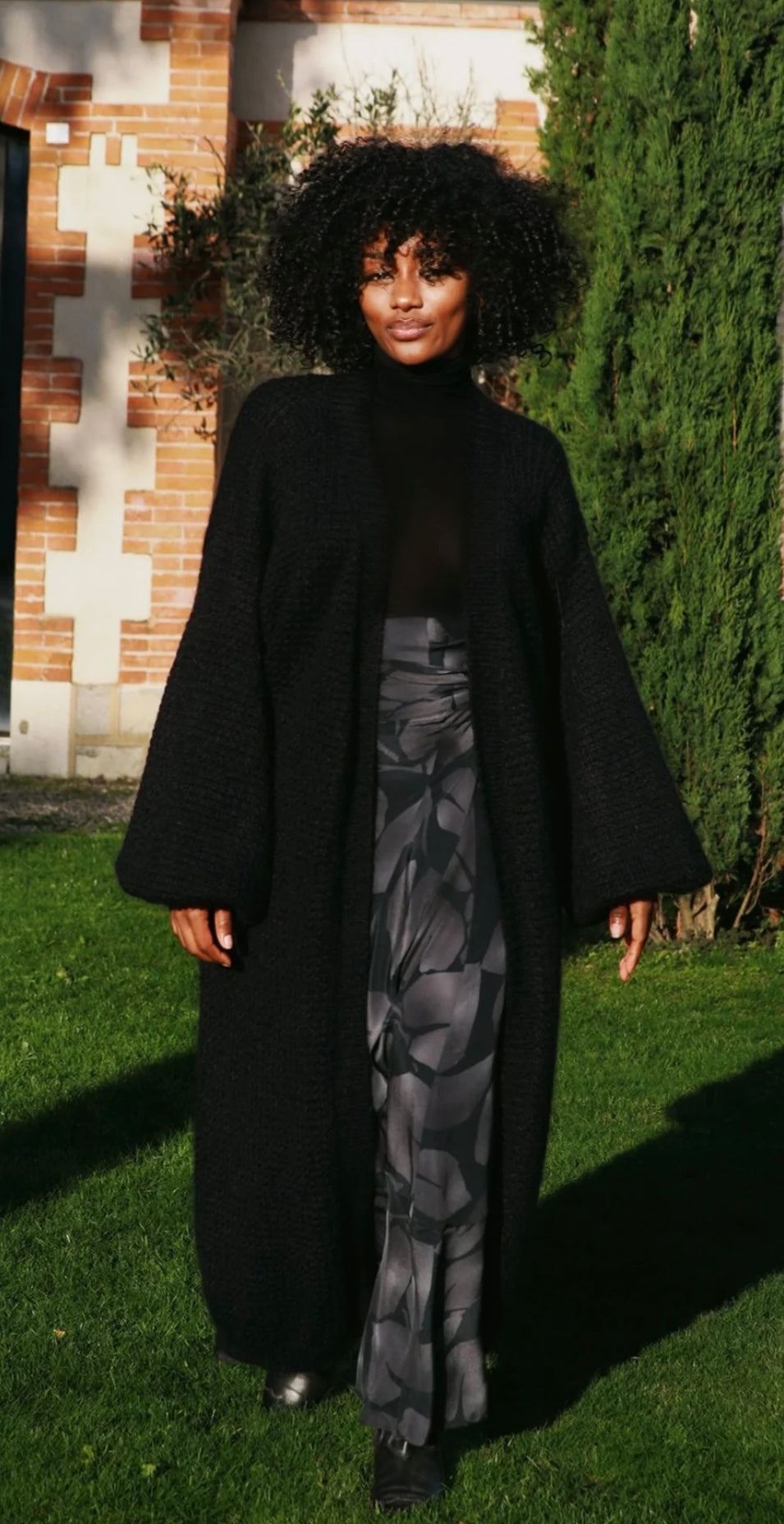 Woman wearing The Long Mohair Coat Noir by HANSINE LONDON outdoors
