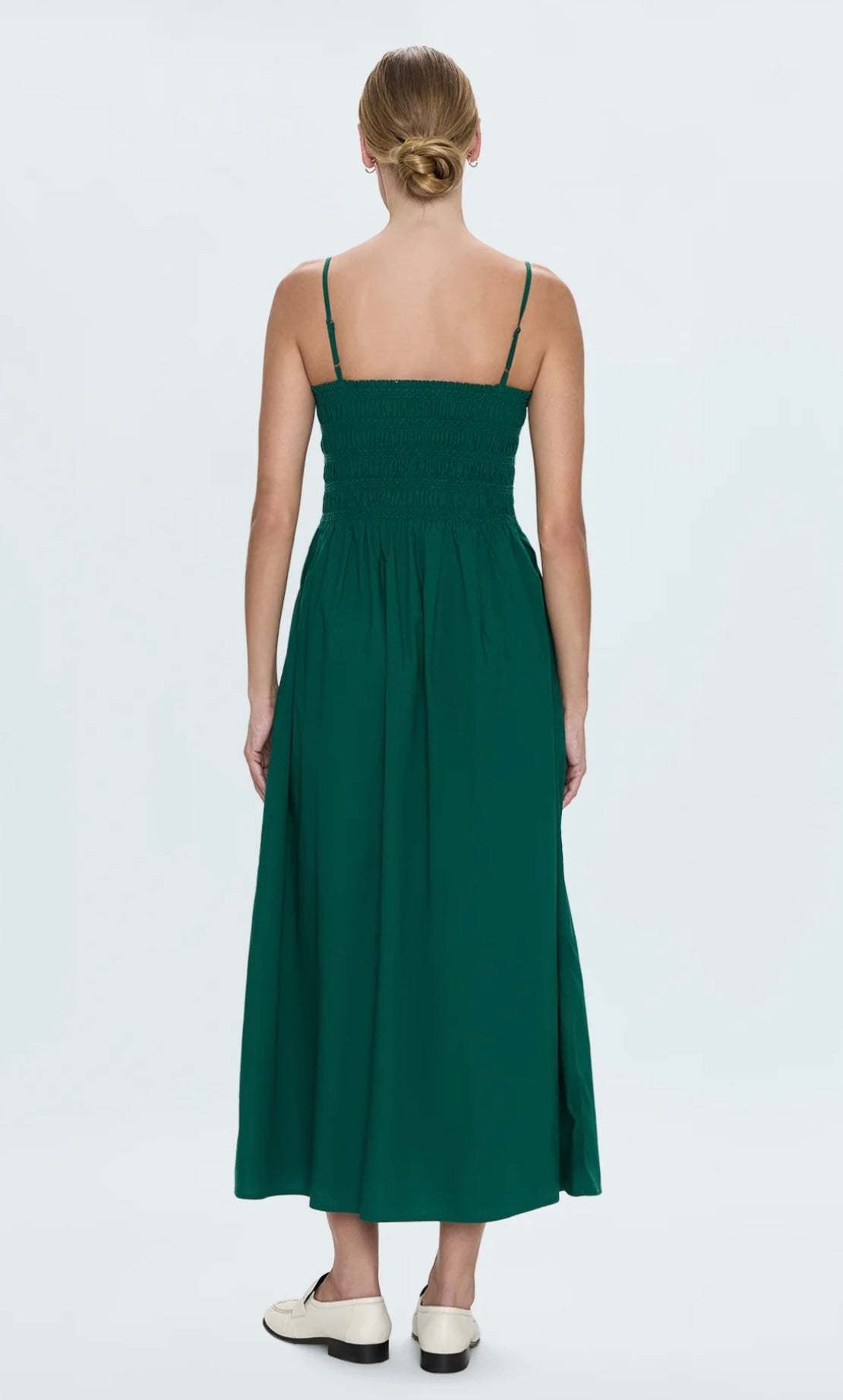 Back view of a woman wearing a flowy Bianca Emerald Dress with thin straps and pockets by PISTOLA DENIM
