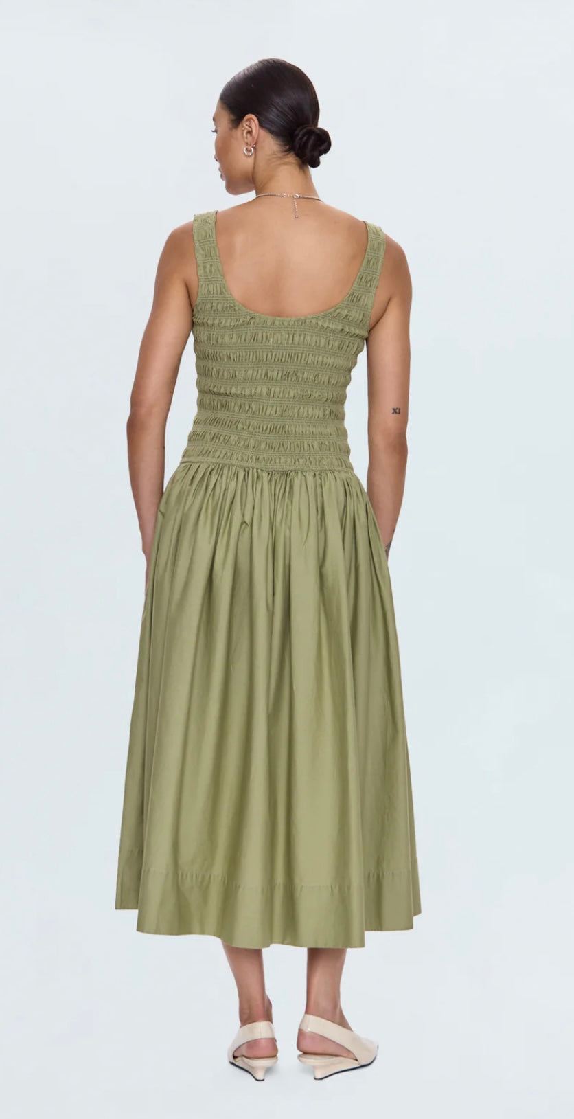 Back view of Alessia Dress in sage with smocked bodice and ruched midi skirt with pockets