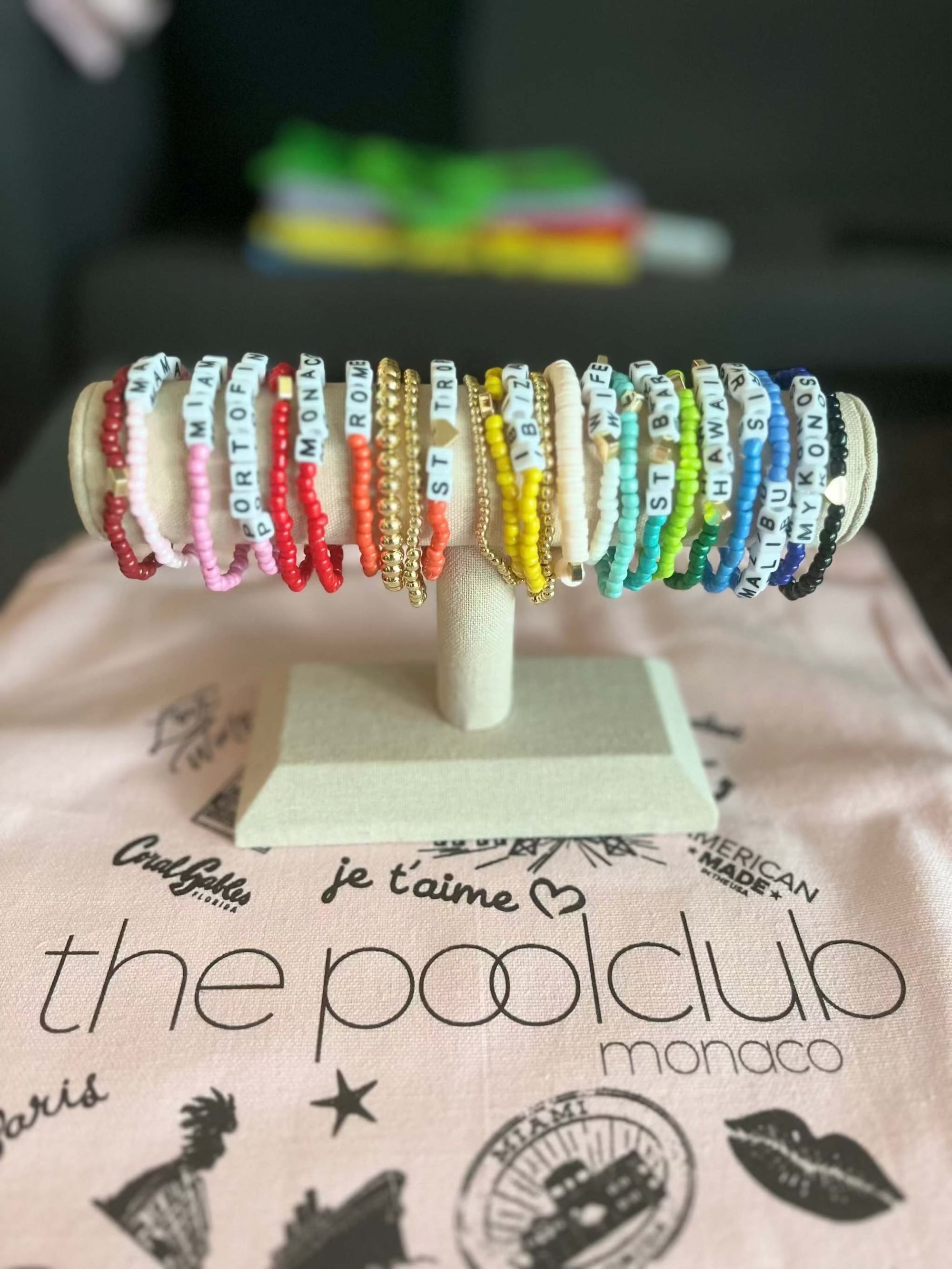 Colorful 18k gold filled ballet charity bracelets displayed on stand supporting Miami dance schools