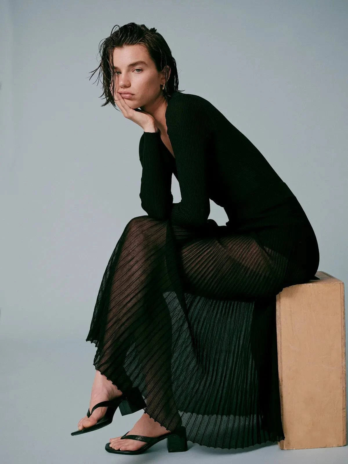 Woman wearing The Theresa Skirt Noir by SOLID&STRIPED, a flowy black maxi skirt with gauzy rib fabric and elastic waistband.