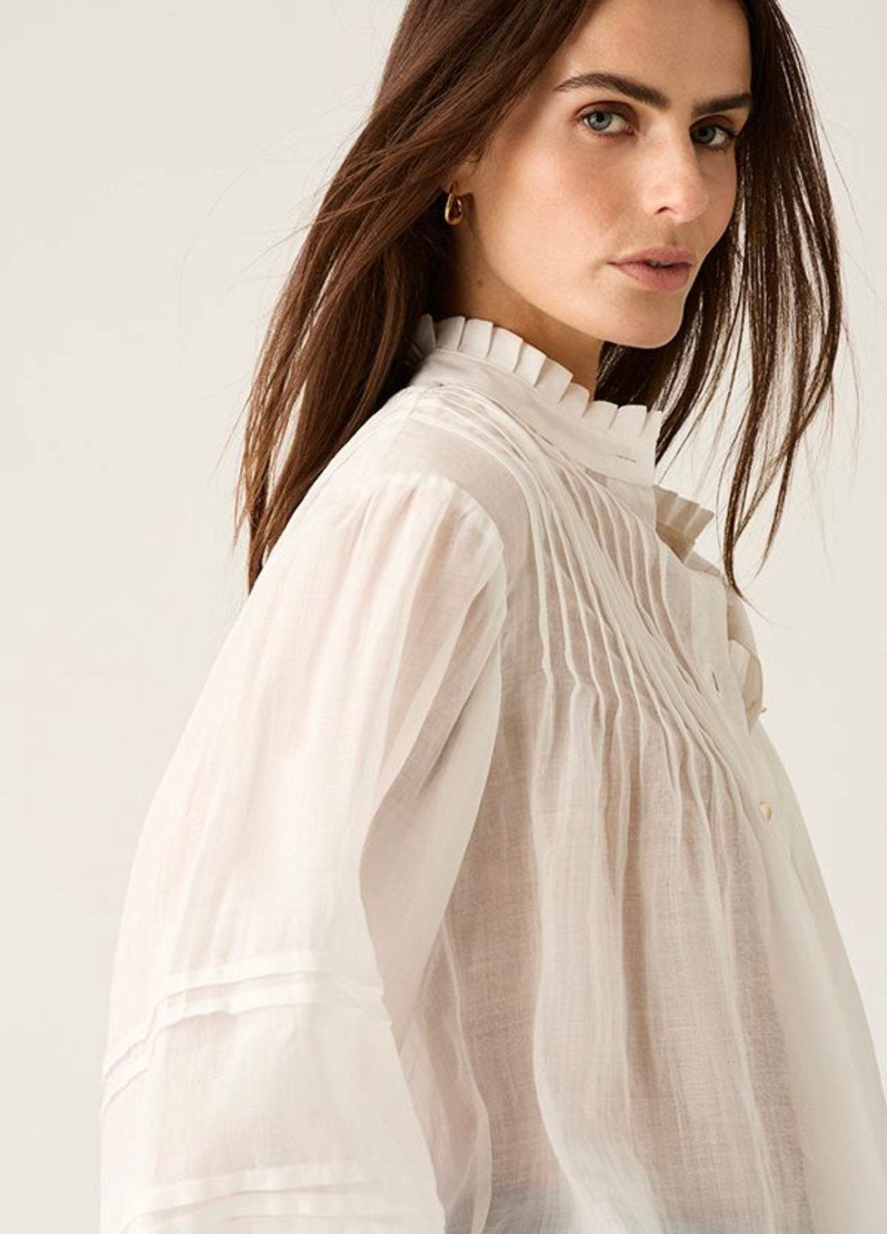 Aaliyah Blouse ivory lightweight semi-sheer pleated shoulder blouse with ruffle neckline and gold buttons