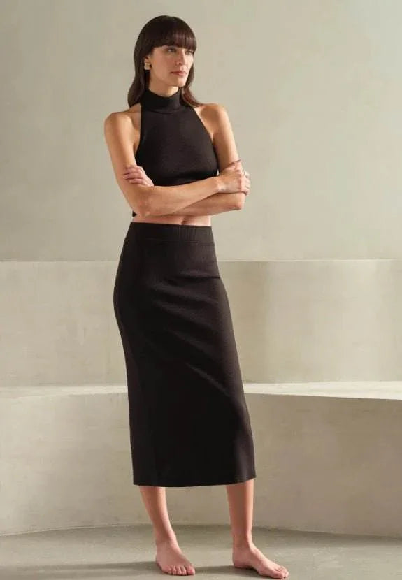 Back Slit LuxRib Midi Skirt in black ribbed fabric with rear slit for easy movement