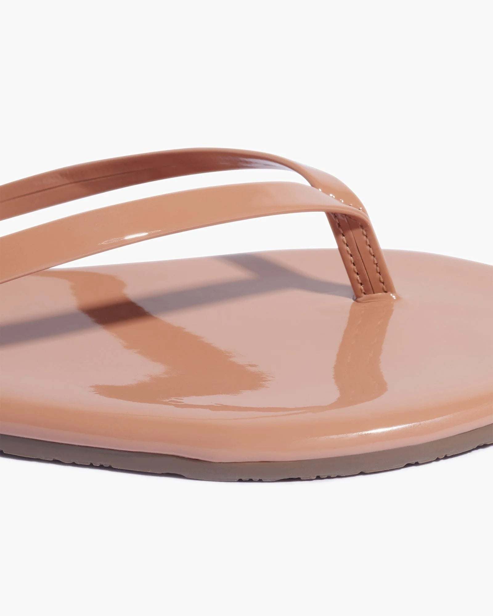 Glossy patent leather Foundation Gloss Cocoabutter flip flop with cushioned insole and rubber outsole