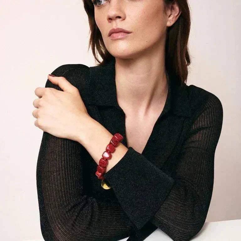 Woman wearing red marble organic shaped beads bracelet by Vanessa Baroni on wrist