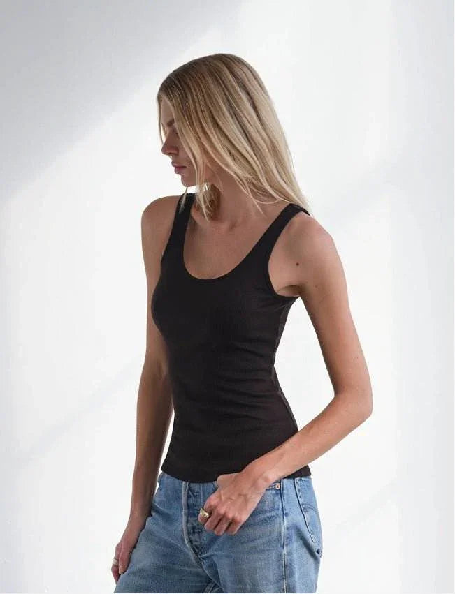woman wearing black MiniRib Tank with blue jeans against white background