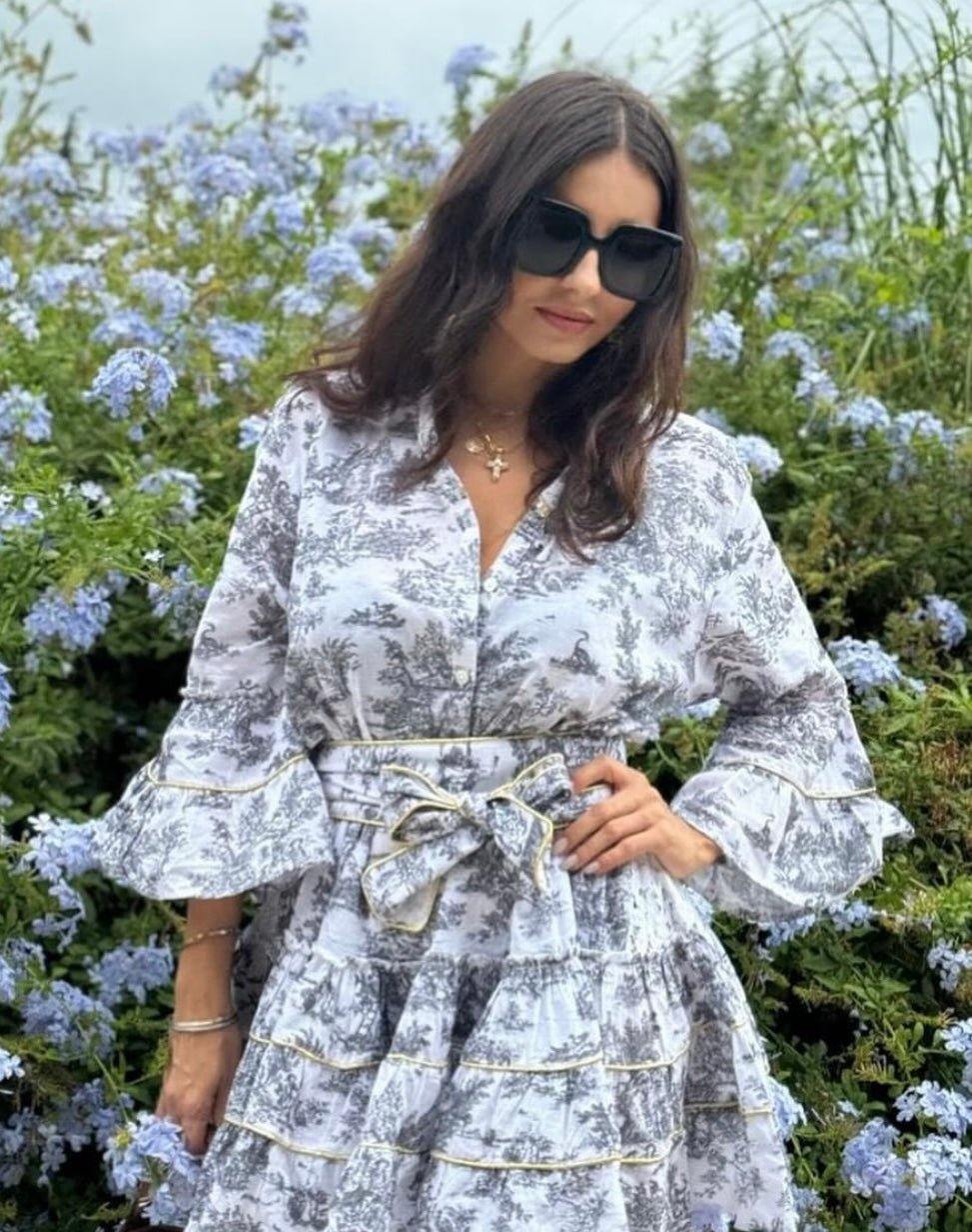 The Monte Carlo LIMITED EDITION floral dress with ruffled sleeves and waist tie worn by woman outdoors