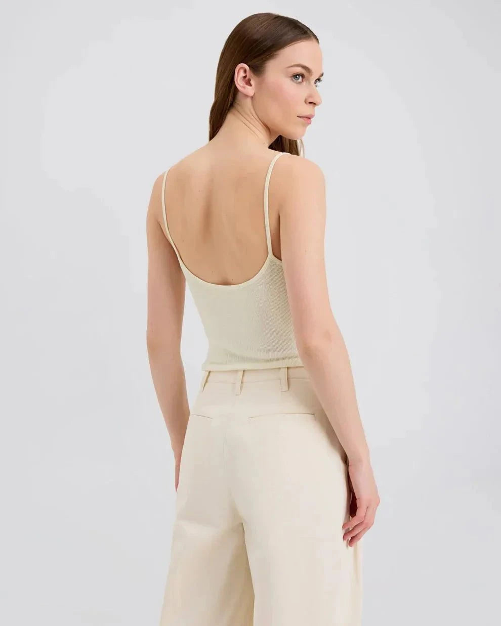 Woman wearing Selena Tank ecru slim fit knit top with square neckline from SOLID&STRIPED Grainge Capsule collection back view