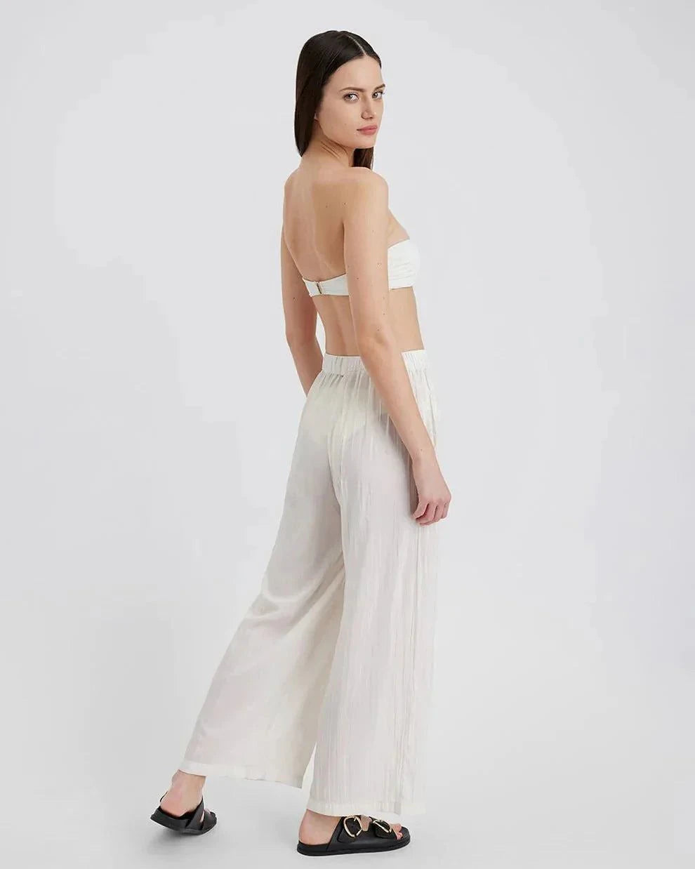 Woman wearing The Milly Pant ecru wide-leg lightweight crinkle fabric with raw hem and high waist